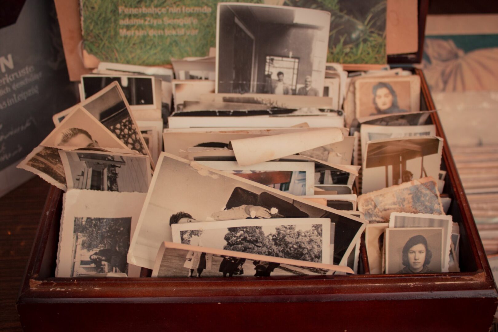 A pile of old photographs sitting on top of a table.